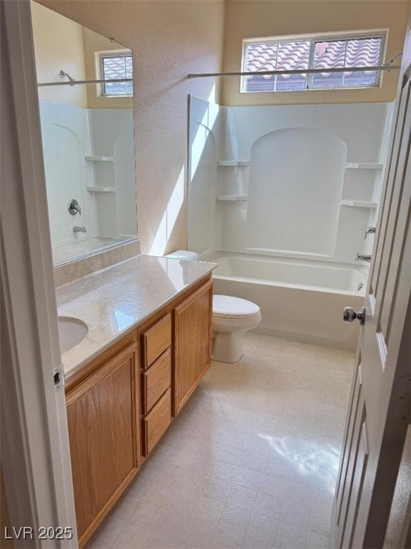 bathroom featuring tub / shower combination, toilet, vanity, and tile patterned floors