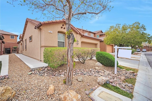 7317 Caballo Range Ave, Las Vegas, NV 89179 - mediterranean / spanish home featuring stucco siding, a garage, and a tile roof