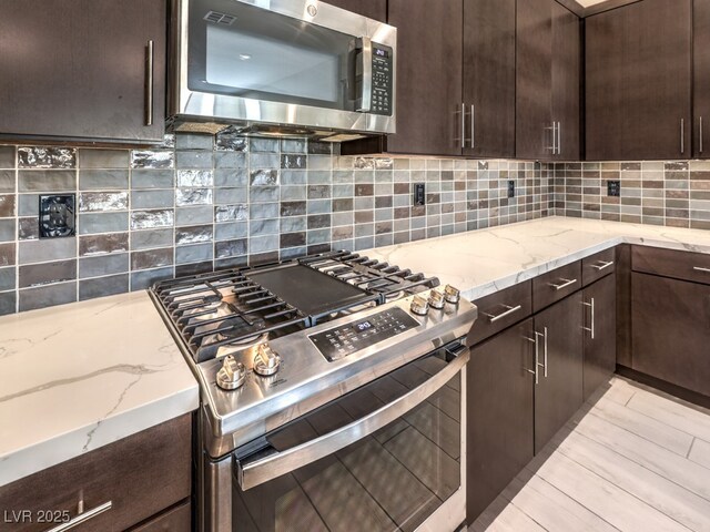 kitchen featuring backsplash, appliances with stainless steel finishes, and dark brown cabinetry