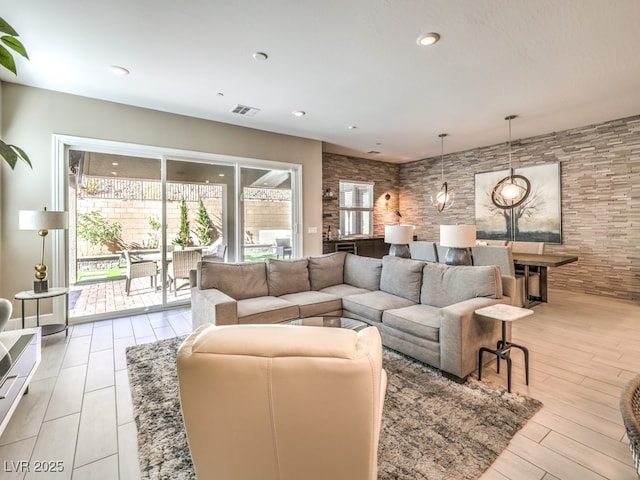 living area with recessed lighting, visible vents, and light wood-type flooring