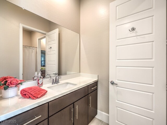 bathroom featuring vanity and baseboards