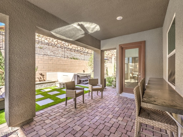 view of patio / terrace featuring fence