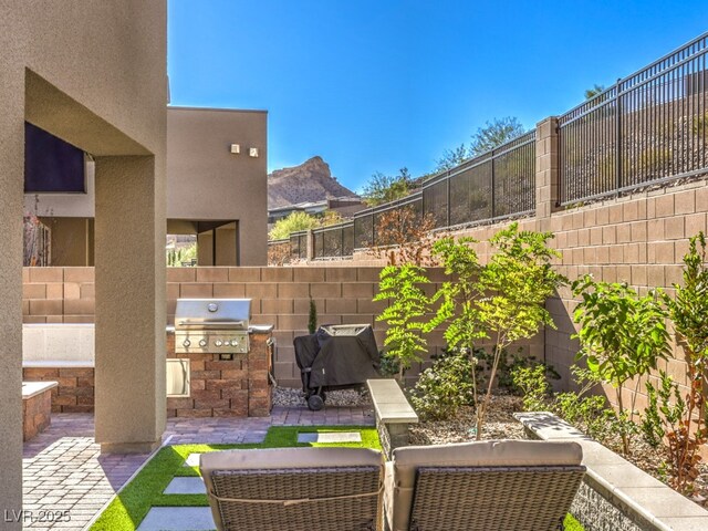 view of patio featuring grilling area and fence