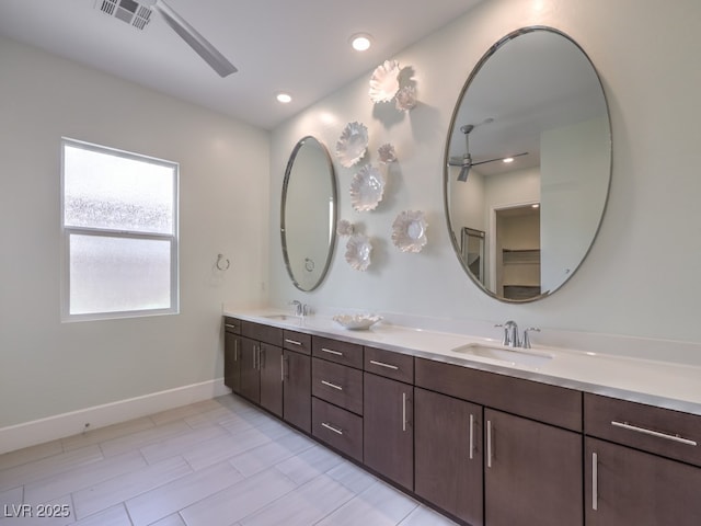 bathroom featuring double vanity, a ceiling fan, visible vents, and a sink