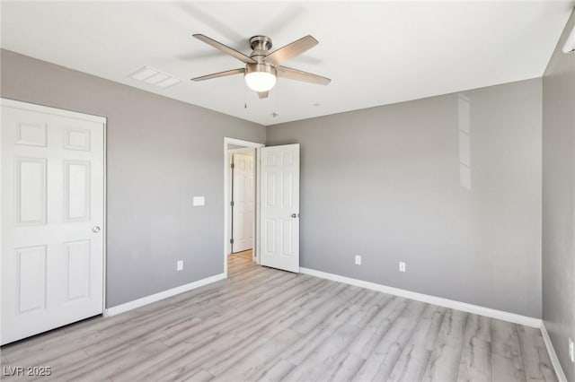 unfurnished bedroom featuring visible vents, light wood-style flooring, baseboards, and ceiling fan