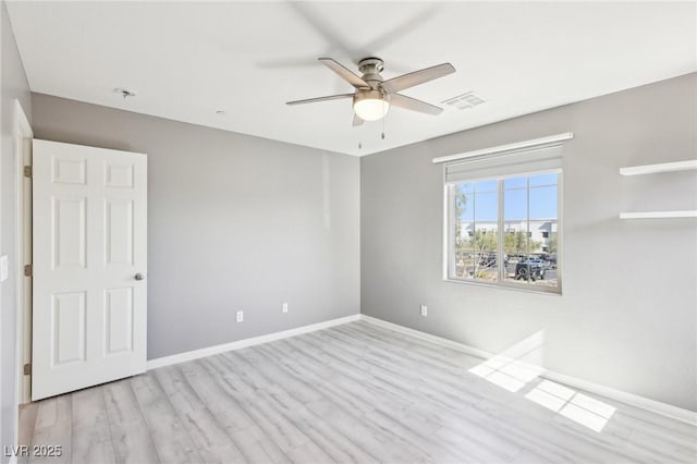 unfurnished bedroom with ceiling fan, wood finished floors, visible vents, and baseboards