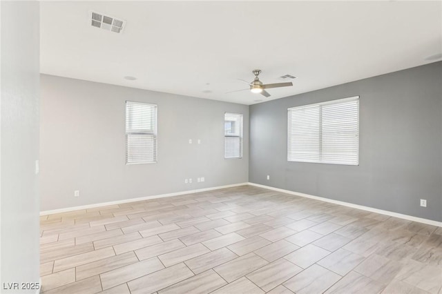 unfurnished room featuring visible vents, baseboards, and ceiling fan