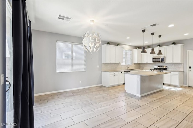 kitchen featuring visible vents, a sink, light countertops, appliances with stainless steel finishes, and tasteful backsplash