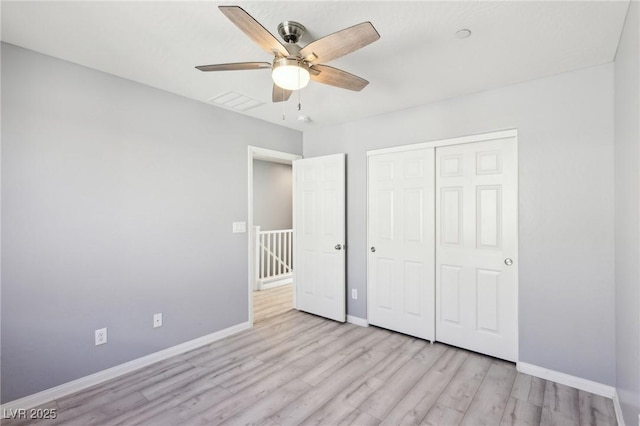 unfurnished bedroom with ceiling fan, a closet, baseboards, and wood finished floors