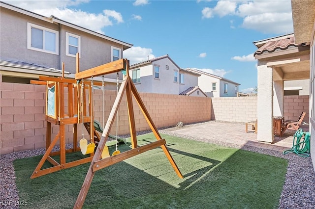 view of jungle gym featuring a patio area and a fenced backyard