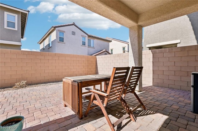 view of patio with outdoor dining area and a fenced backyard