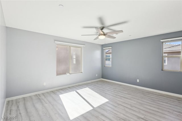 unfurnished room featuring baseboards, wood finished floors, and a ceiling fan