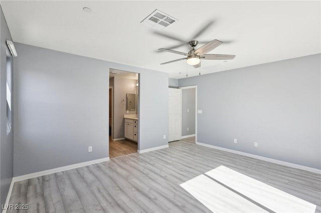 unfurnished bedroom featuring visible vents, baseboards, ensuite bath, ceiling fan, and light wood-style floors