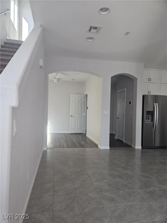 interior space with visible vents, arched walkways, and baseboards