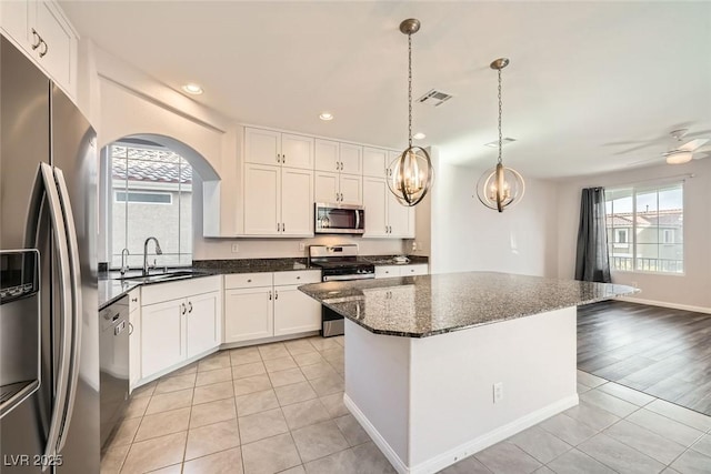 kitchen with white cabinets, visible vents, appliances with stainless steel finishes, and a sink