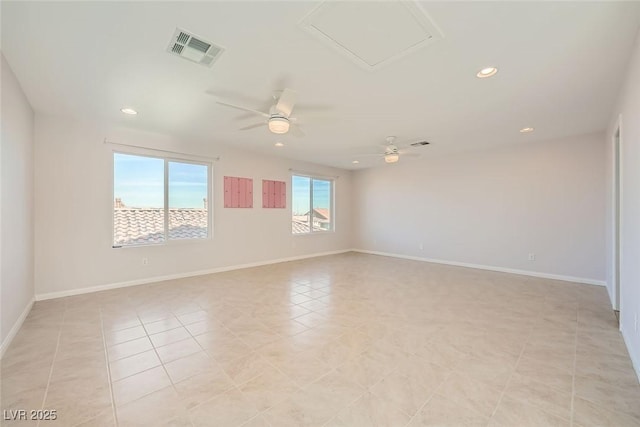 empty room with light tile patterned flooring, visible vents, recessed lighting, and baseboards