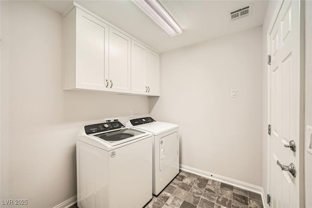 laundry room featuring visible vents, cabinet space, baseboards, and washing machine and dryer