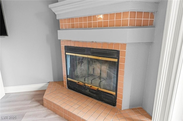 details featuring a fireplace and baseboards