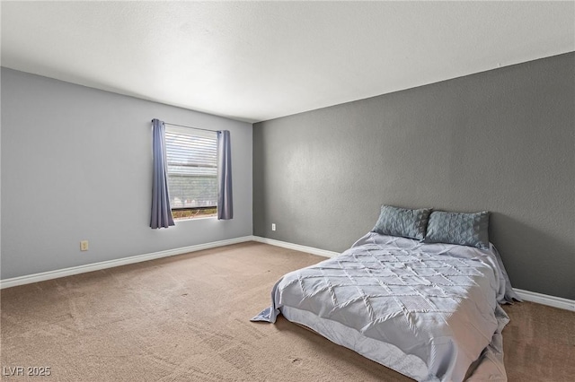 unfurnished bedroom featuring carpet flooring and baseboards