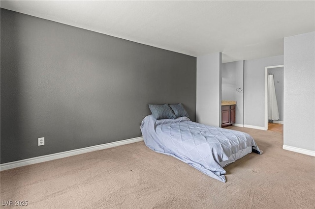 bedroom with baseboards and light carpet