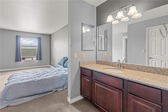 bathroom featuring baseboards and vanity