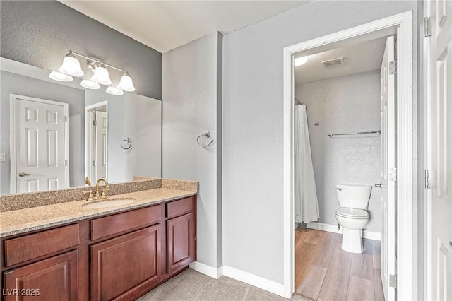 full bathroom with vanity, wood finished floors, visible vents, baseboards, and toilet