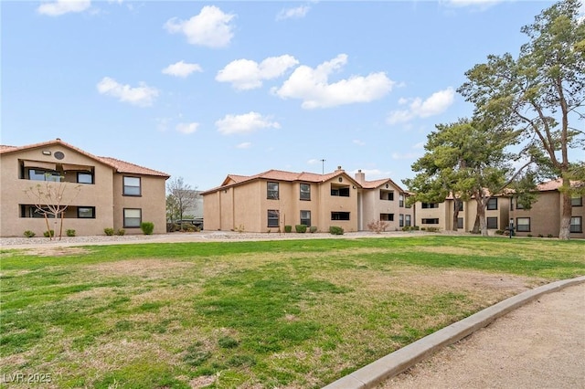 view of home's community featuring a lawn