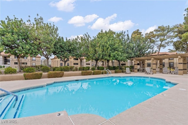 pool with a patio and fence