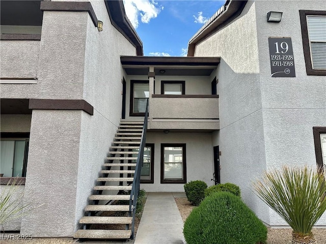 entrance to property featuring stucco siding