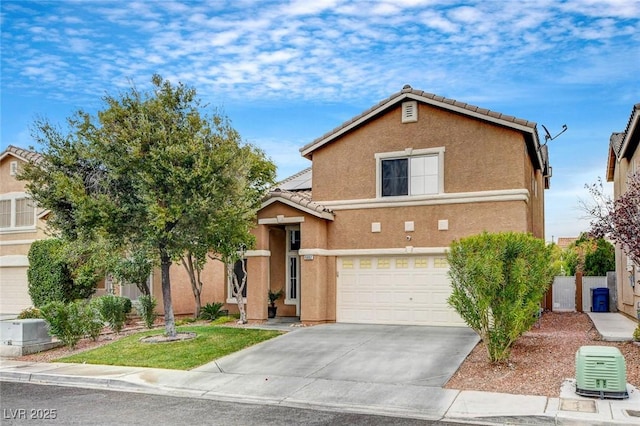 view of front of property with a tiled roof, a garage, driveway, and stucco siding