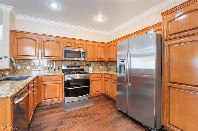 kitchen featuring crown molding, decorative backsplash, appliances with stainless steel finishes, dark wood-style floors, and a sink