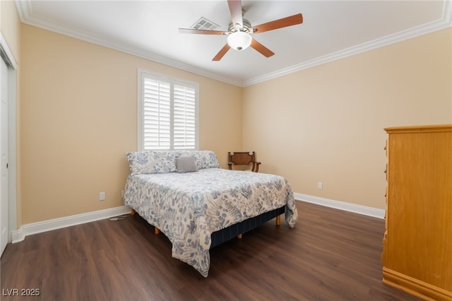 bedroom with dark wood finished floors, baseboards, and ornamental molding