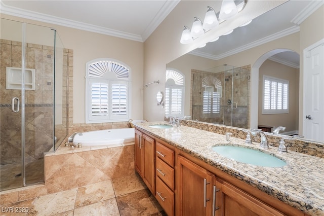 bathroom featuring a sink, a stall shower, and crown molding