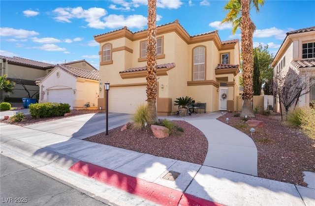 mediterranean / spanish home featuring stucco siding, a tiled roof, concrete driveway, and a garage