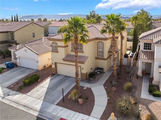 mediterranean / spanish-style house with stucco siding, concrete driveway, a garage, a tile roof, and a residential view