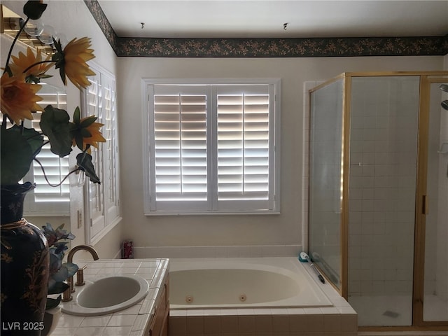 full bath featuring plenty of natural light, a stall shower, and a tub with jets