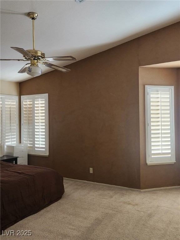 carpeted bedroom with lofted ceiling and ceiling fan