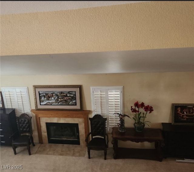 living room featuring a tile fireplace