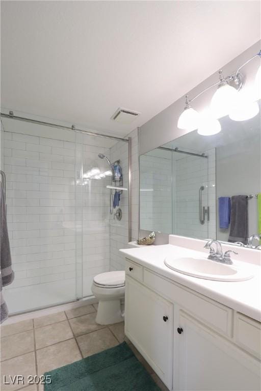 bathroom with vanity, visible vents, a stall shower, tile patterned floors, and toilet