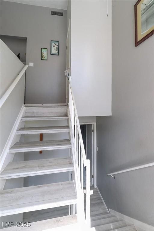 stairs featuring visible vents and baseboards