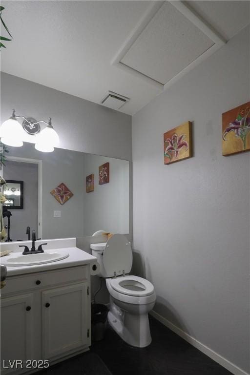 half bath with vanity, toilet, baseboards, and visible vents