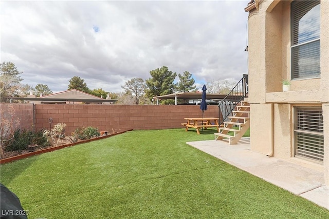 view of yard with stairway and a fenced backyard