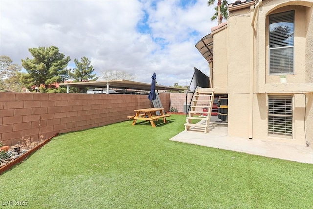 view of yard with stairs, a patio, and a fenced backyard