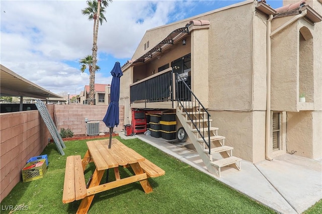 view of yard with a patio, cooling unit, and fence