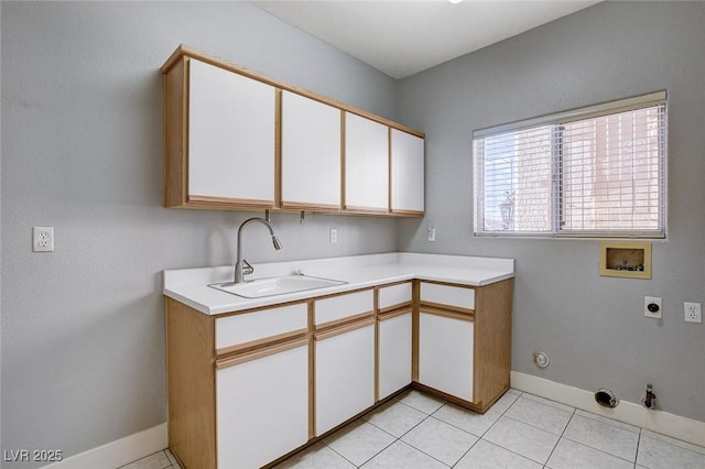 washroom with hookup for a washing machine, hookup for a gas dryer, light tile patterned flooring, hookup for an electric dryer, and a sink