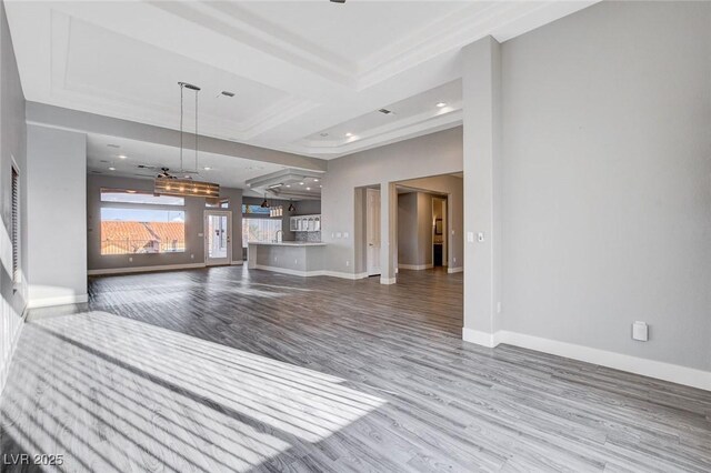 unfurnished living room featuring recessed lighting, baseboards, and wood finished floors