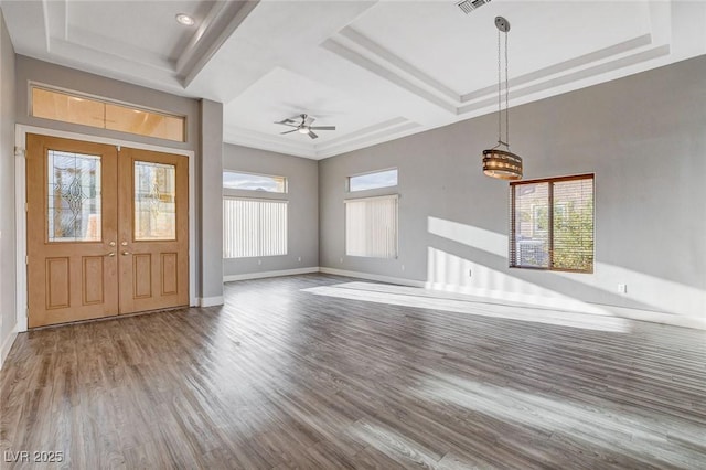 entryway with a raised ceiling, wood finished floors, baseboards, and french doors