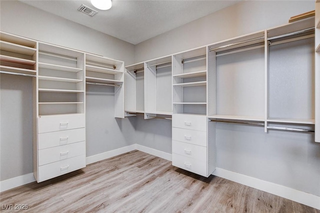 spacious closet with wood finished floors and visible vents