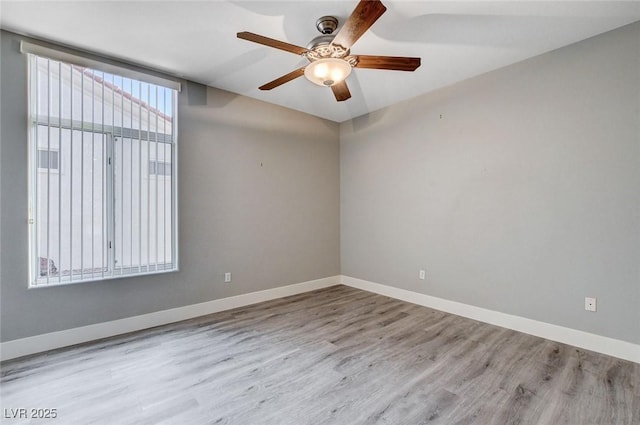 unfurnished room featuring wood finished floors, baseboards, and ceiling fan