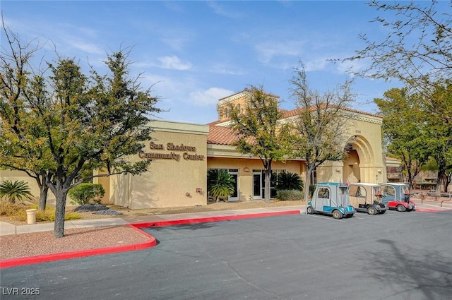 view of building exterior featuring uncovered parking